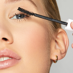 woman applying mascara