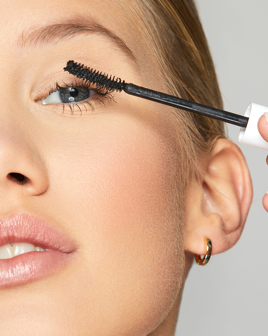 woman applying mascara